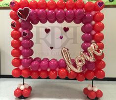 a valentine's day balloon frame with the word love spelled out