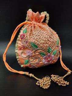 "floral texture zardosi thread embroider peach silk hand bag for woman designer | wedding favor drawstring purse pouch with beaded chain Package Contents: 1 Size: 10\" x 8\" Designed with the heart, this beautiful Potli or batawa bag are eye catchy and made of premium material. Key Features: Zardosi embroidery art work. This potli is good match with both Indian and western outfits and are superb for wedding and festive parties. This would be best complement to your designer saree, lenhga or any Pink Rectangular Potli Bag With Zari Work, Pink Bags With Dori Work For Gift, Gold Potli Bag With Resham Embroidery For Festivals, Rectangular Pink Potli Bag With Zari Work, Traditional Pink Bag With Dori Work, Traditional Pink Bags With Dori Work, Pink Zari Work Potli Bag For Festivals, Elegant Pink Potli Bag With Dori Work, Pink Zari Work Potli Bag For Diwali