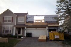 a house under construction with boxes on the driveway