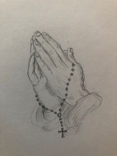 a drawing of a praying hand with a rosary