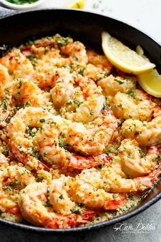 a skillet filled with shrimp and cheese