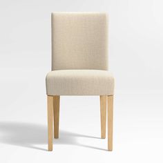 a white upholstered chair with wooden legs and backrests, viewed from the side