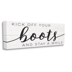 a wooden sign that says kick off your boots and stay a while on the wall