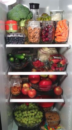 an open refrigerator filled with lots of food and fruit in it's shelves,