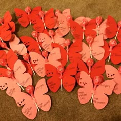 valentine's day heart shaped candy lollipops are arranged on the floor