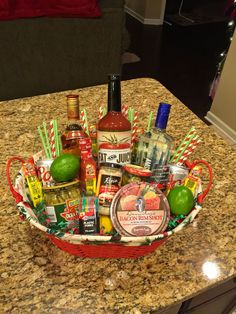 a red basket filled with lots of liquor and condiments on top of a counter