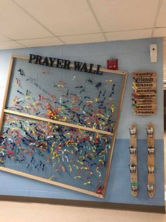 a bulletin board that says prayer wall with confetti sprinkles on it