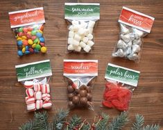 the candy bags are filled with different types of candies and chocolates, along with pine branches