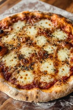 a pizza sitting on top of a wooden table