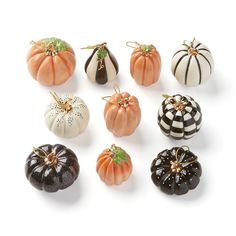 twelve miniature pumpkins in different colors and designs