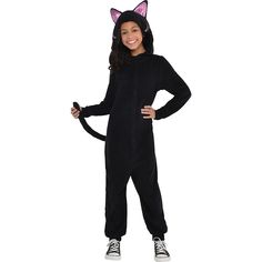 a girl in a black cat costume standing with her hands on her hips and smiling