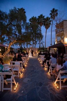 a couple getting married at their wedding ceremony on the beach in front of palm trees