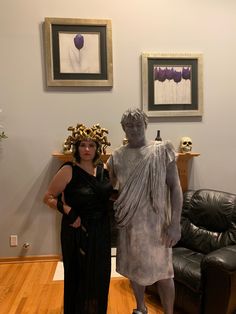 a woman standing next to a statue in a living room