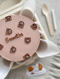 a pink cake with teddy bears on it