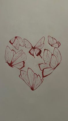 some red butterflies flying in the shape of a heart