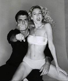 a man and woman posing for a black and white photo