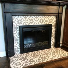 a fireplace with a white and black tile on it