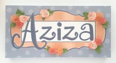 a handmade sign with flowers and the word aziza on it's side