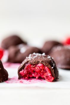 chocolate covered strawberries are sitting on a white surface next to some other desserts