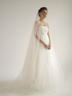 a woman in a white wedding dress and veil