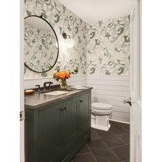 a bathroom with a sink, toilet and mirror