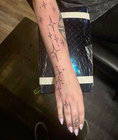 a woman's hand with tattoos on it