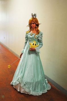 a woman in a princess costume holding a wand