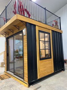 a building made out of shipping containers with stairs and railings on the top floor