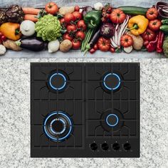 an image of a stove top with vegetables on the burners and in front of it