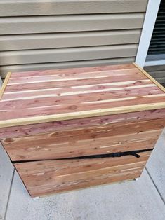 a wooden box sitting on the side of a house