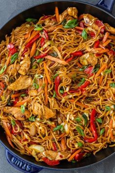 a wok filled with noodles and vegetables