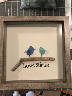 two birds are sitting on a branch with the words love birds