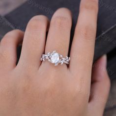 a woman's hand with a diamond ring on it