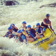 a group of people riding on the back of a raft