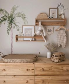 a baby's room is decorated in neutrals and whites, including palm trees