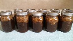 six jars filled with food sitting on top of a blue towel