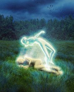 a person laying in the grass with a light painted on their body and hands behind them