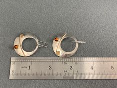 These handmade silver earrings feature matching amber cabochons, and have ear wires, for pierced ears. The earrings measure about 1 3/4 inches long, and about 1 1/4 inches across. These earrings have a combined weight of about 5.7 grams, making them lightweight and comfortable to wear. Although apparently unmarked, the earrings do acid-test as silver. These earrings are in very good, clean original condition, with no apparent issues. Please see photos for details. US buyers only, please. Free sh Handmade Silver Earrings, Faux Pearl Bracelet, Silver Earrings Handmade, Faux Pearl Necklace, Enamel Earrings, Enamel Flower, Pierced Ears, Pearl Bracelet, Earings Piercings