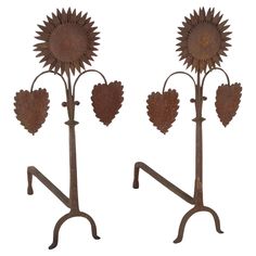 three metal sunflowers with hearts on them are standing next to eachother