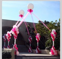 the entrance to a building decorated with balloons and streamers