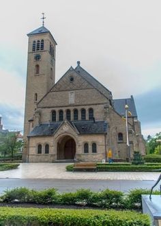 an old church with a clock tower in the middle of it's front yard