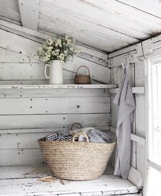 a basket sitting on top of a shelf next to a window