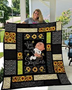 a woman holding up a quilt with the words you are sunshine and sunflowers on it