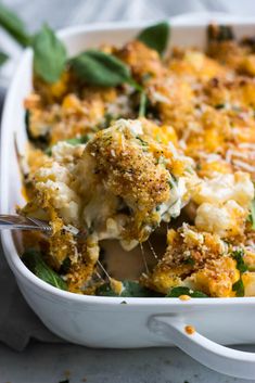 a casserole dish with broccoli and cheese in it, ready to be eaten