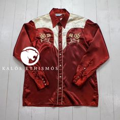 Drape yourself in the vintage charm of this silky red satin Western shirt by KALÓS ETHISMÓS. Adorned with delicate floral and branch embroidery, every stitch tells a story of timeless elegance and masterful craftsmanship. The pearl snap buttons and sleek satin fabric make it a piece that stands out while still offering a hint of rugged Western appeal. Whether it's for a special occasion or an elevated streetwear look, this shirt is designed to captivate. Product Details: - Intricate flower and branch embroidery - Lustrous red satin finish - Pearl snap buttons for a refined touch - Long sleeves with Western-style detailing - Ideal for both streetwear and gifting Welcome to KALÓS ETHISMÓS! We want to ensure your shopping experience is delightful and transparent. Please take a moment to revie Fitted Embroidered Red Shirt, Red Party Shirt With Button Closure, Red Button Closure Party Shirt, Red Button Closure Shirt For Party, Fitted Red Embroidered Shirt, Branch Embroidery, Embroidered Western Shirt, Elevated Streetwear, Rockabilly Fashion