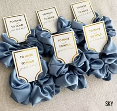 six blue scrunffles with gold foil on them and some white cards in the middle