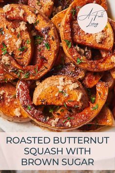 roasted butternut squash with brown sugar and herbs in a white bowl on a wooden table