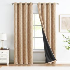 a living room scene with focus on the window curtain and curtains hanging in front of it