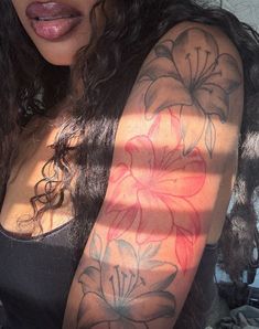 a woman's arm with flowers painted on it