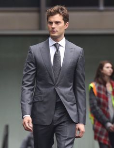 a man in a suit walking down the street